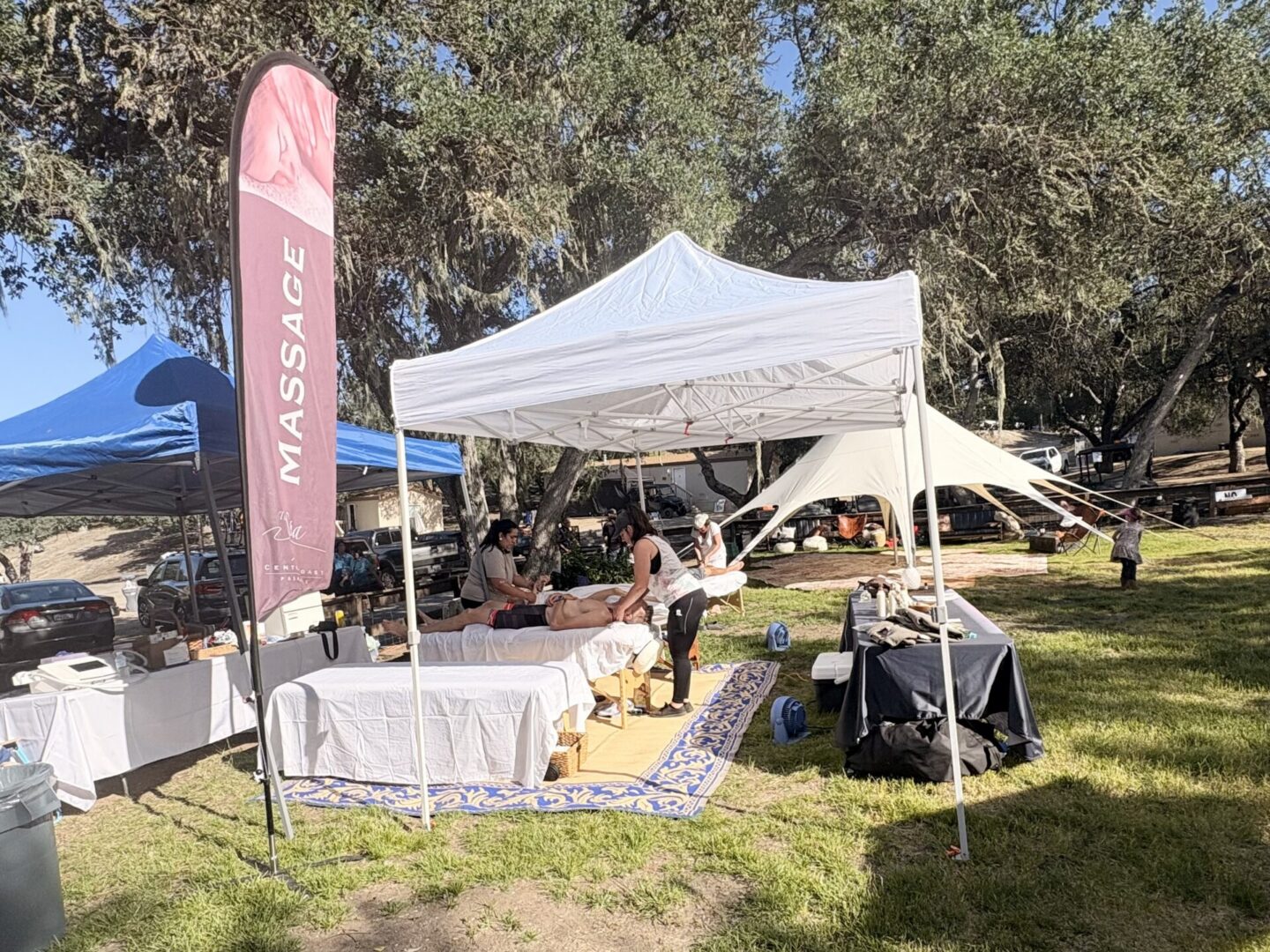 Outdoor massage tent with therapist and tables