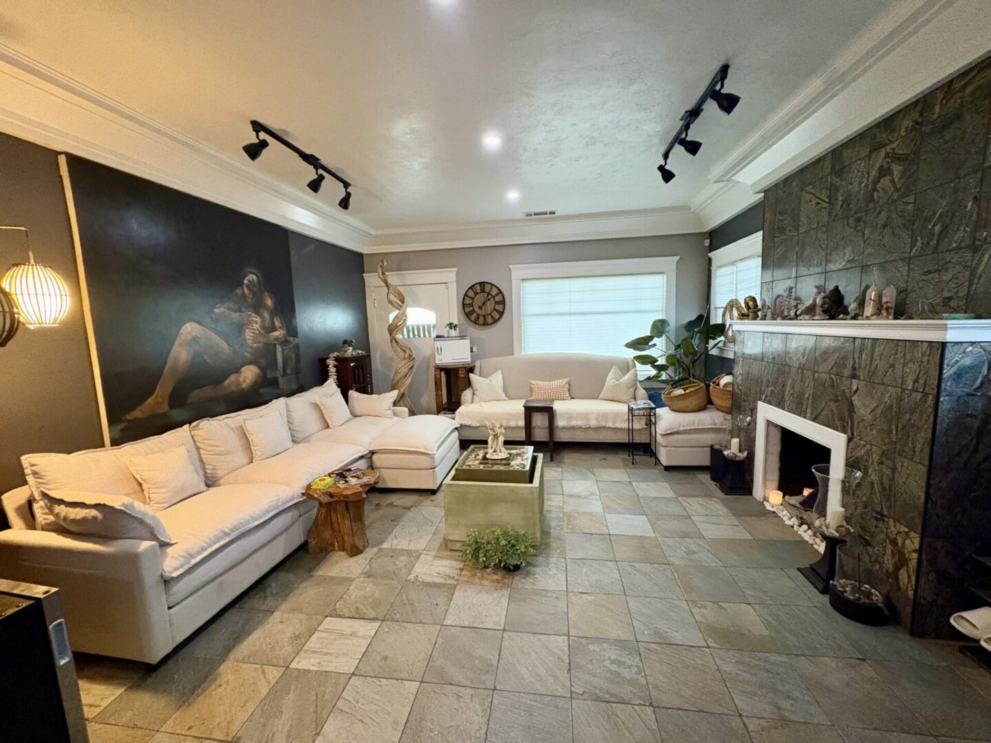 Cozy living room with white sofas and fireplace